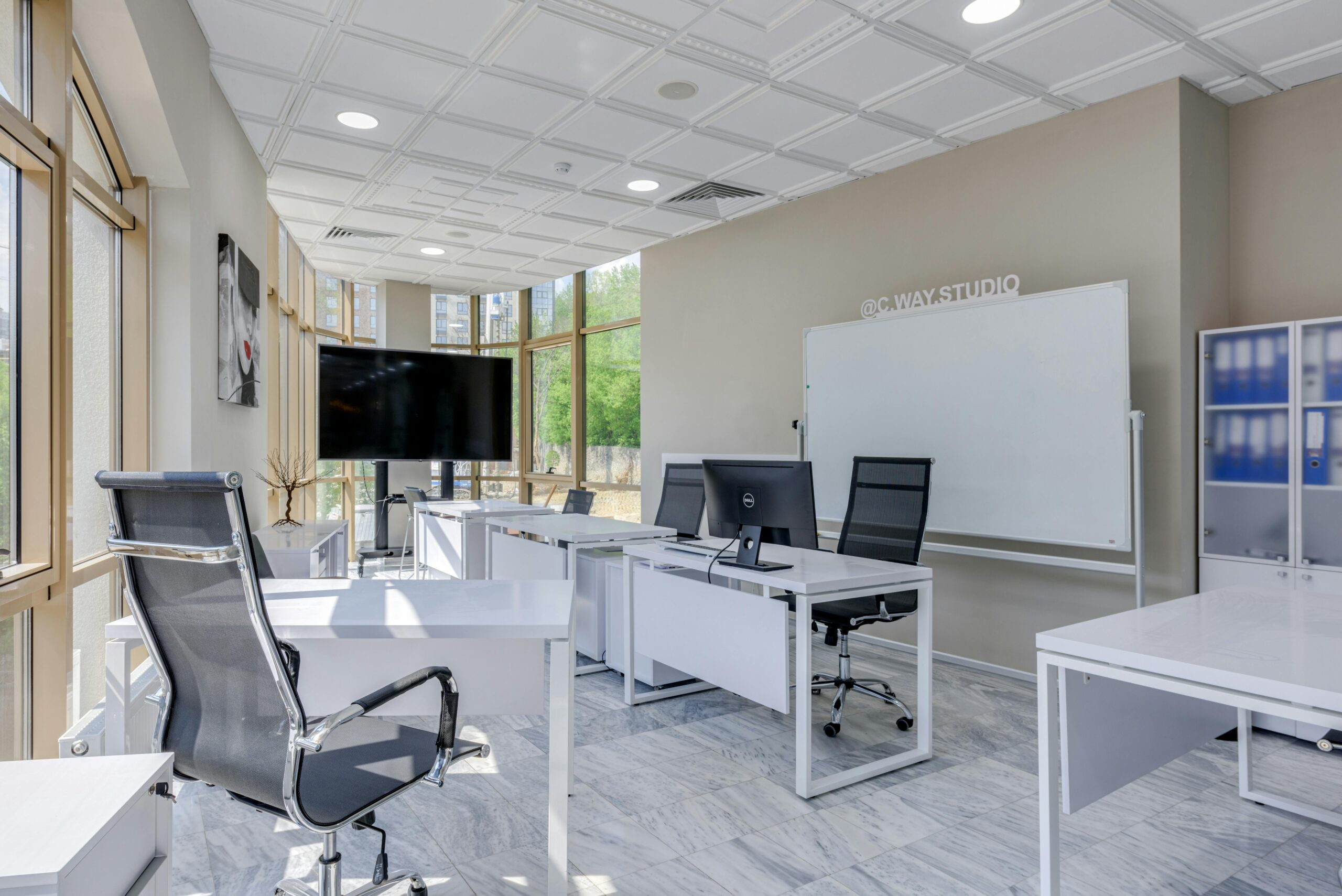 Spacious and bright modern office interior with sleek furniture, ideal for professional workspaces.